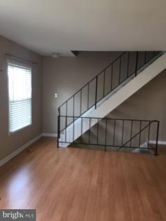 99 Ridgelawn Road, Unit A Reisterstown, MD 21136 - Photo 7 of 10 Living room with view of stairs to bedroom level