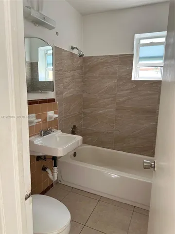 a bathroom with a sink a toilet and bathtub