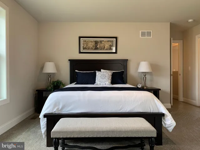 a spacious bedroom with a bed and a couch
