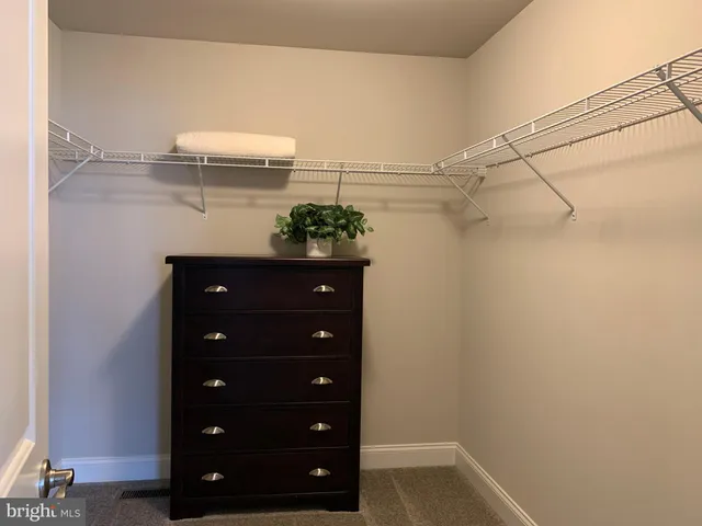 a bedroom with a bed and a lamp on table