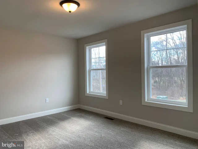 a white bath tub sitting in a bathroom next to a window