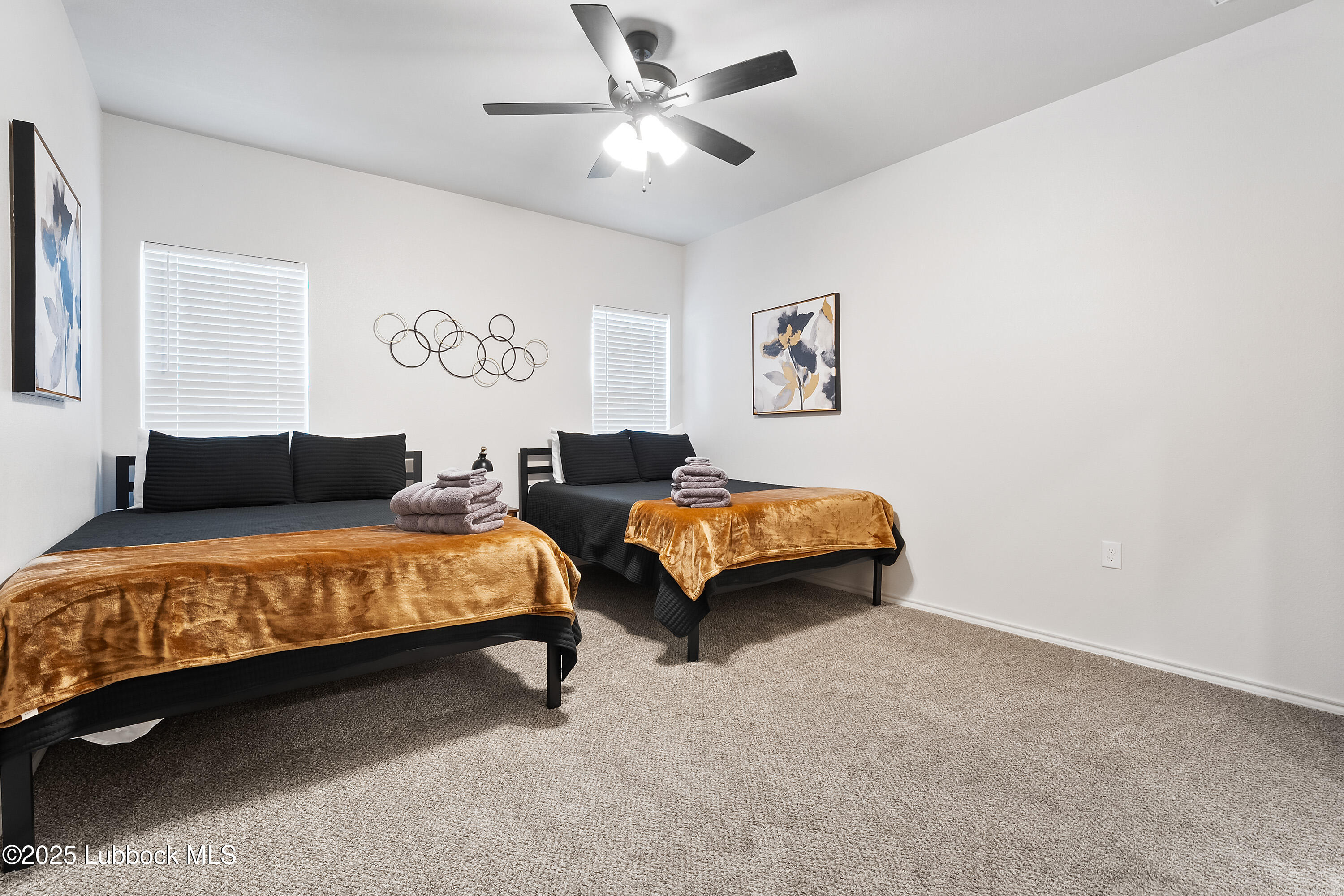 5528 Lehigh Street Lubbock, TX 79416 - Photo 18 of 23 a spacious bedroom with a bed and a chandelier