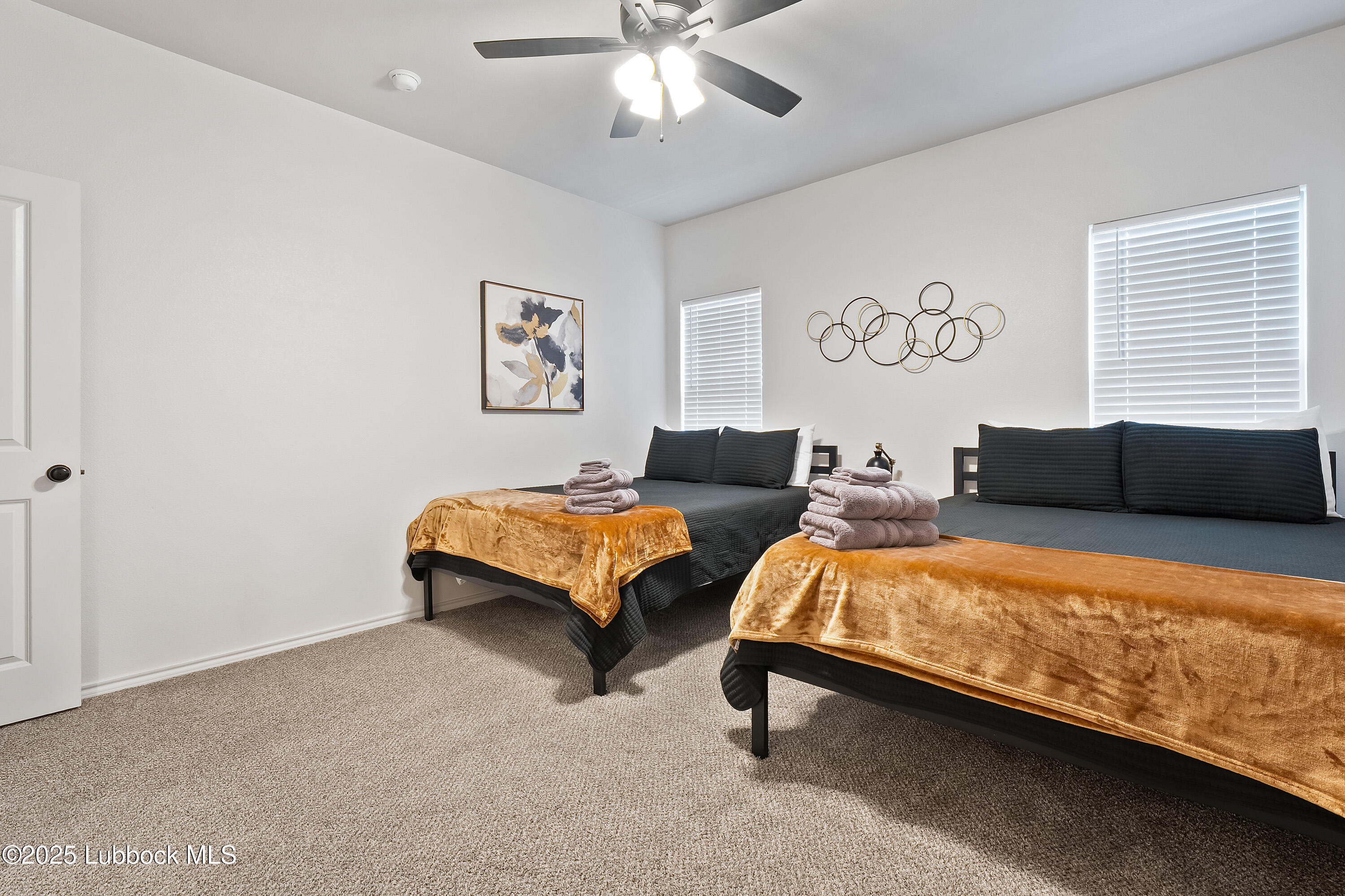 5528 Lehigh Street Lubbock, TX 79416 - Photo 19 of 23 a bedroom with 2 bed and a chandelier