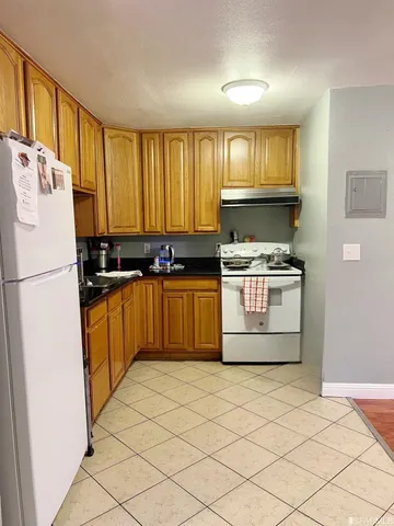 a kitchen with stainless steel appliances granite countertop a stove a sink and a refrigerator