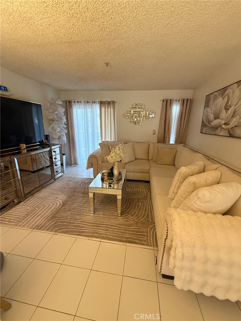 450 East 4th Street, Unit 103 Santa Ana, CA 92701 - Photo 1 of 10 a living room with furniture and a flat screen tv