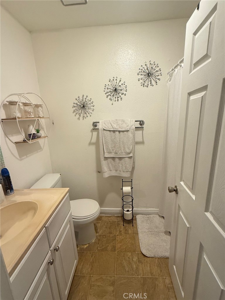 450 East 4th Street, Unit 103 Santa Ana, CA 92701 - Photo 2 of 10 a bathroom with a sink a toilet and a mirror