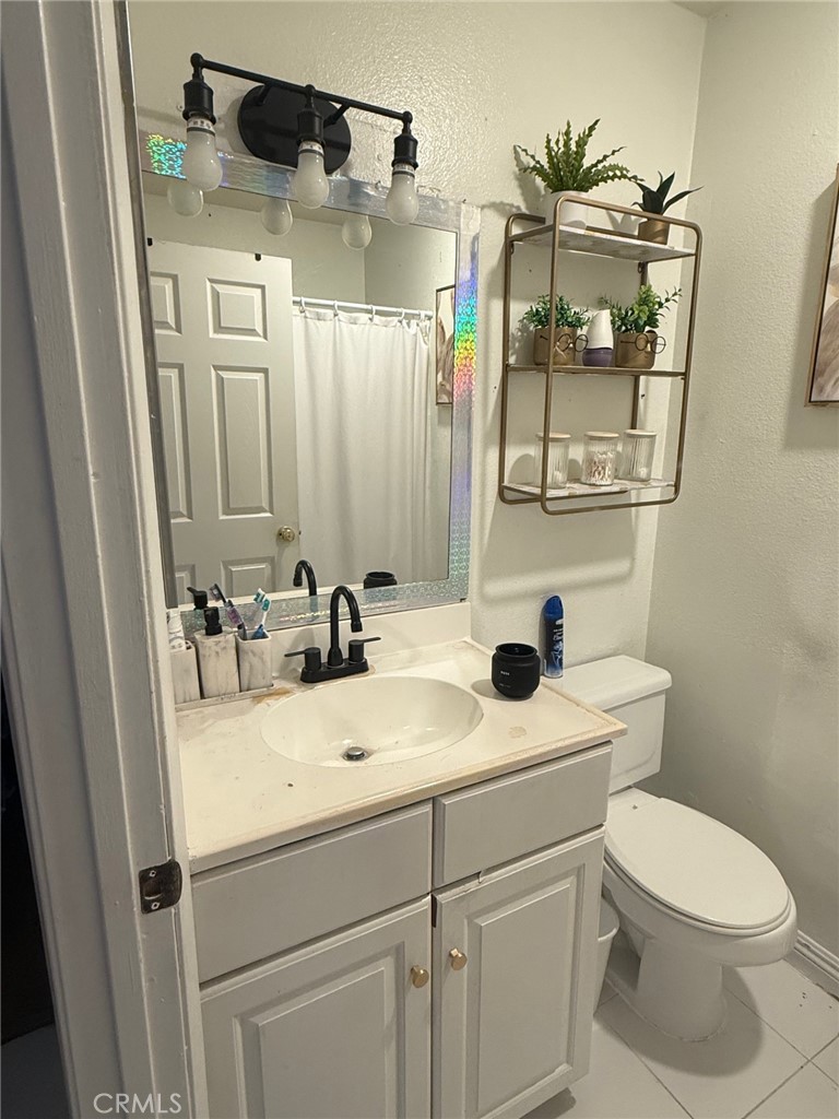 450 East 4th Street, Unit 103 Santa Ana, CA 92701 - Photo 3 of 10 a bathroom with a sink and mirror with toilet