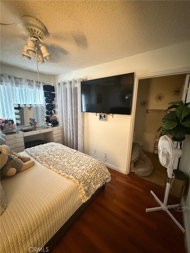 450 East 4th Street, Unit 103 Santa Ana, CA 92701 - Photo 5 of 10 a bedroom with a bed and a chandelier