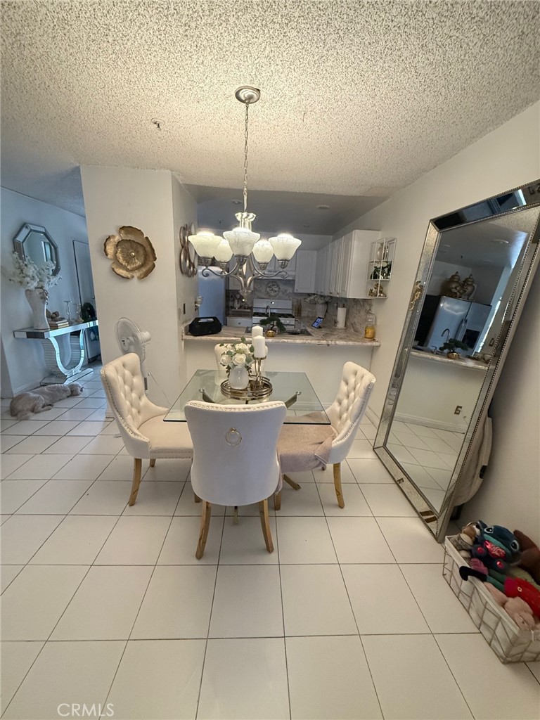 450 East 4th Street, Unit 103 Santa Ana, CA 92701 - Photo 6 of 10 a dining room with furniture and a chandelier