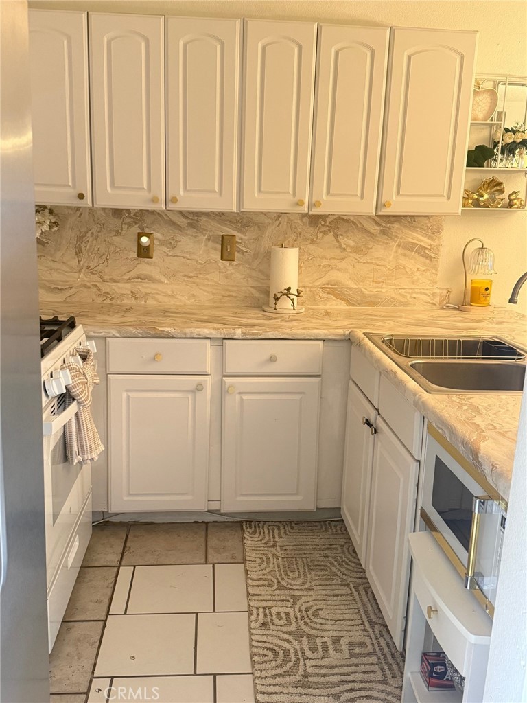 450 East 4th Street, Unit 103 Santa Ana, CA 92701 - Photo 7 of 10 a kitchen with a sink and cabinets