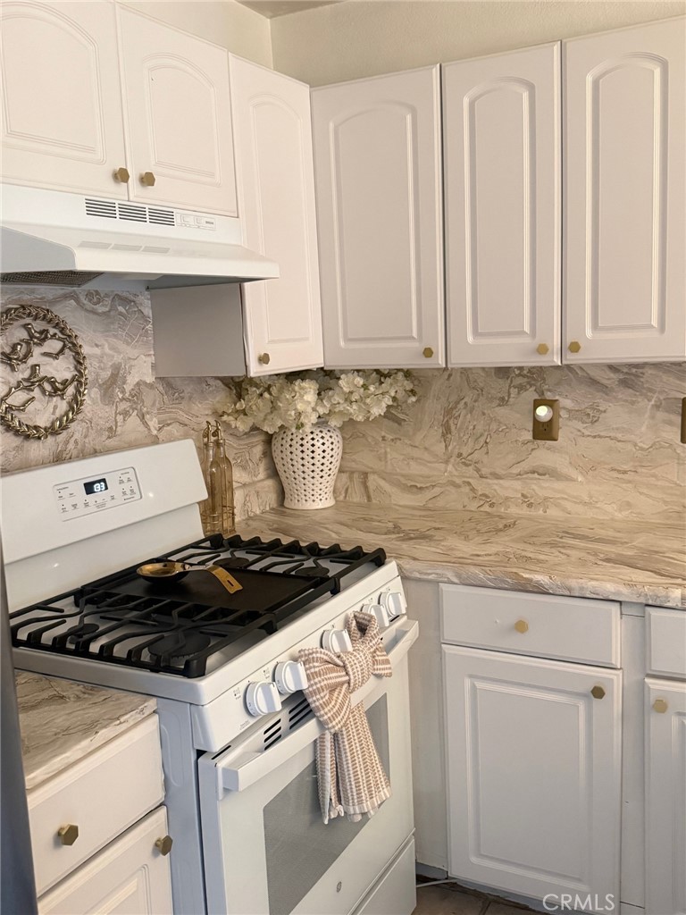 450 East 4th Street, Unit 103 Santa Ana, CA 92701 - Photo 8 of 10 a white stove top oven sitting inside of a kitchen