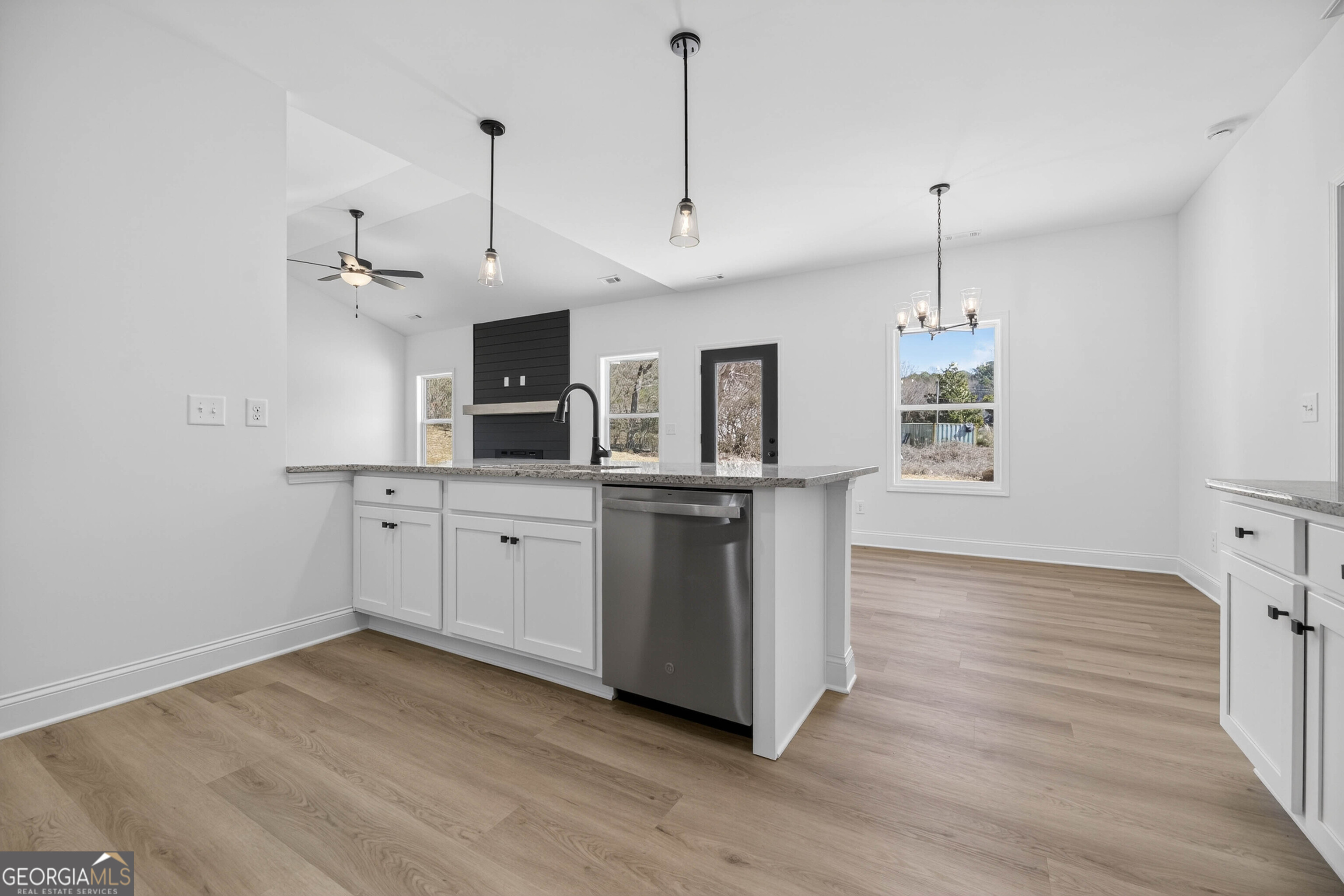 707 Oakmont Trail Villa Rica, GA 30180 - Photo 11 of 33 a kitchen with stainless steel appliances granite countertop a sink a stove a microwave and wooden floor