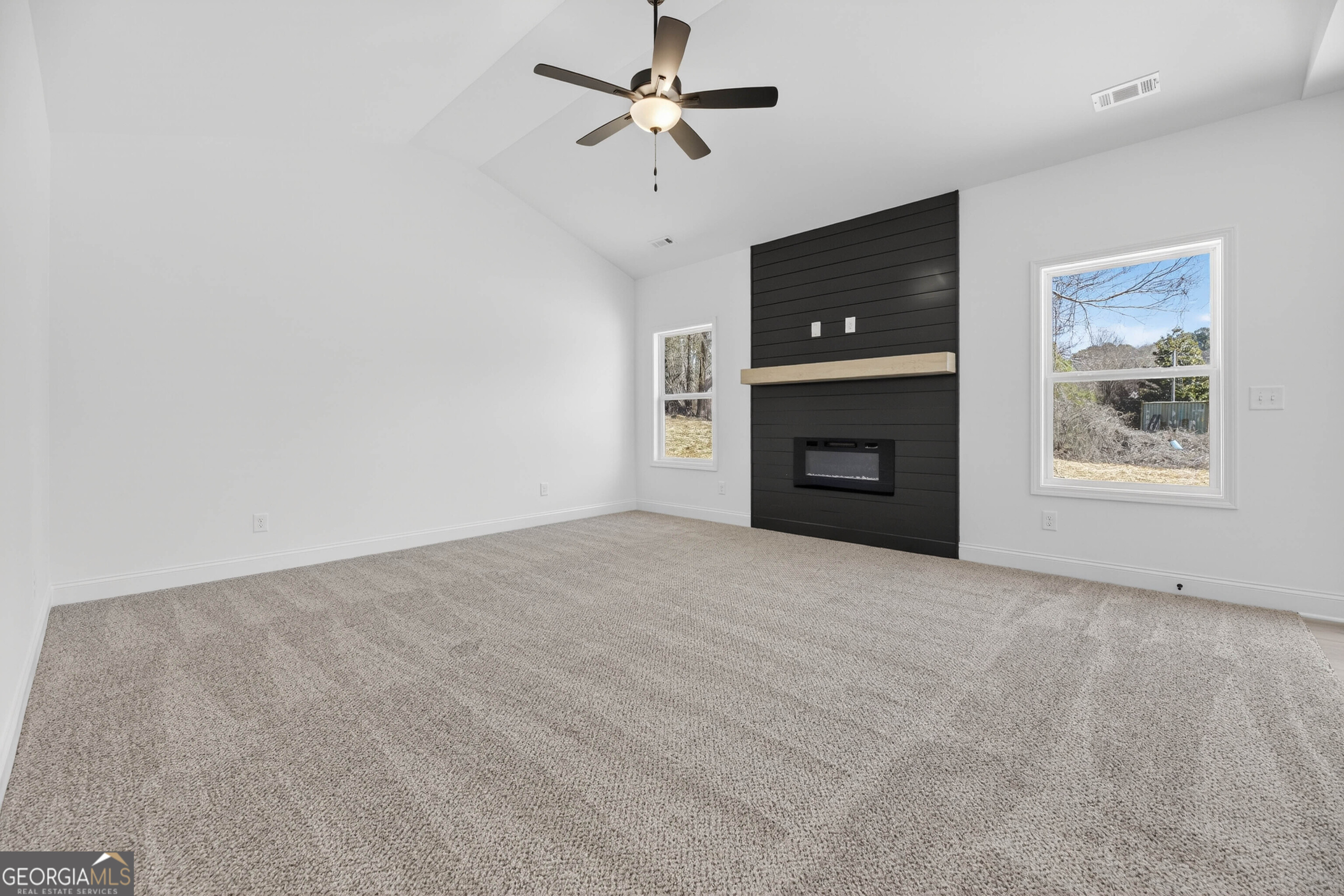 707 Oakmont Trail Villa Rica, GA 30180 - Photo 5 of 33 a view of an empty room with a ceiling fan and window