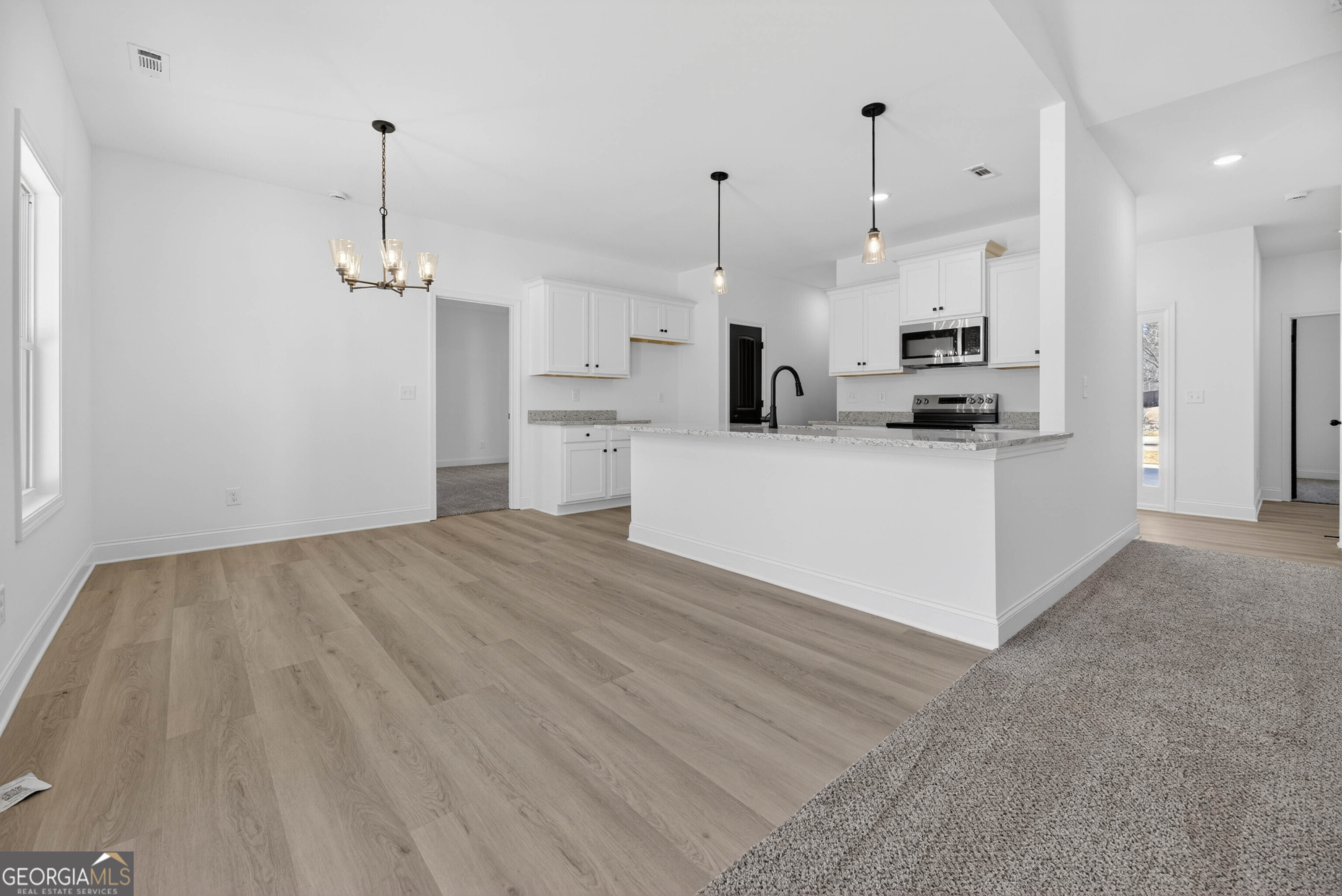 707 Oakmont Trail Villa Rica, GA 30180 - Photo 6 of 33 a view of a kitchen with kitchen island a sink stainless steel appliances and cabinets