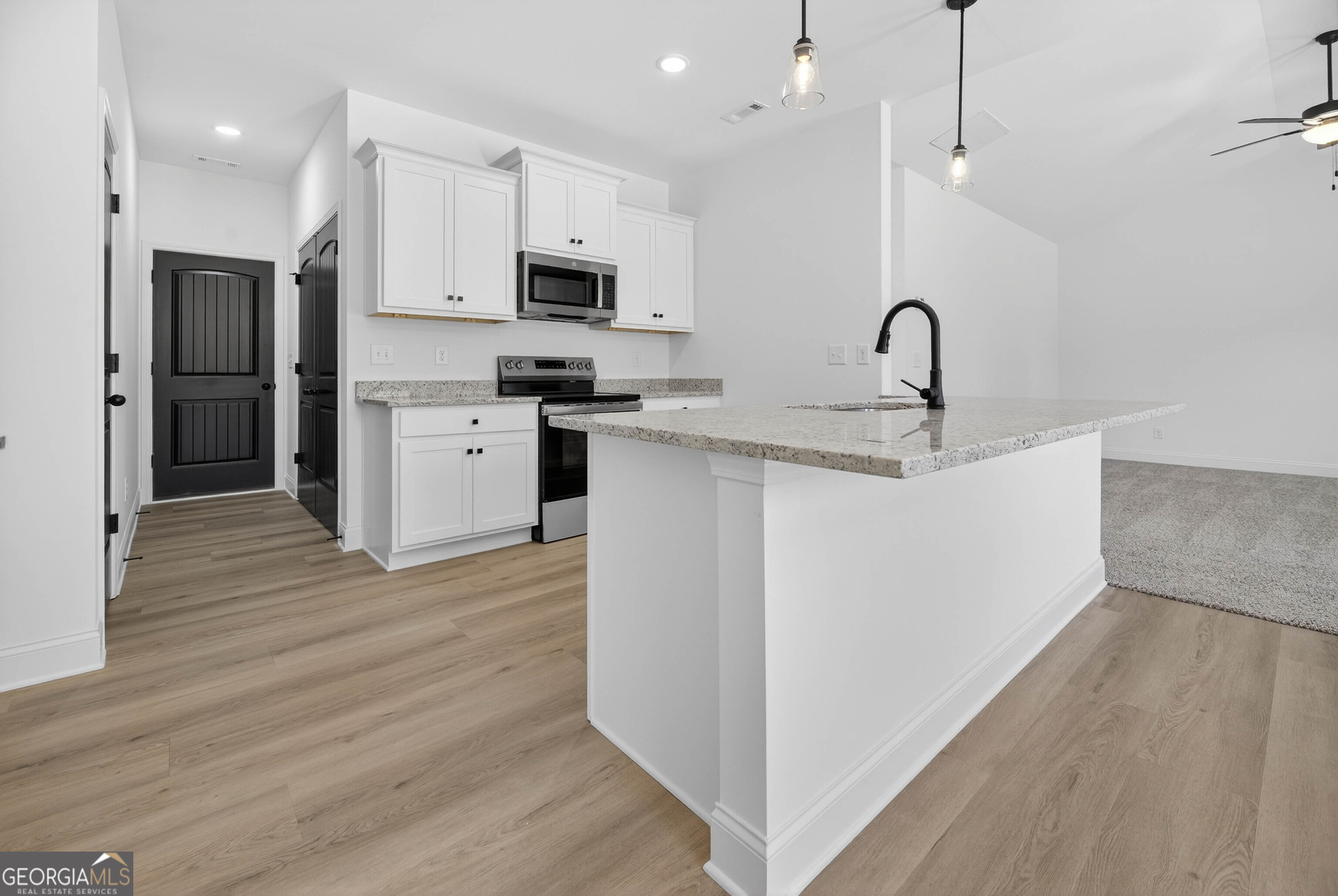 707 Oakmont Trail Villa Rica, GA 30180 - Photo 8 of 33 a kitchen with stainless steel appliances a sink dishwasher a refrigerator and a oven with wooden floor