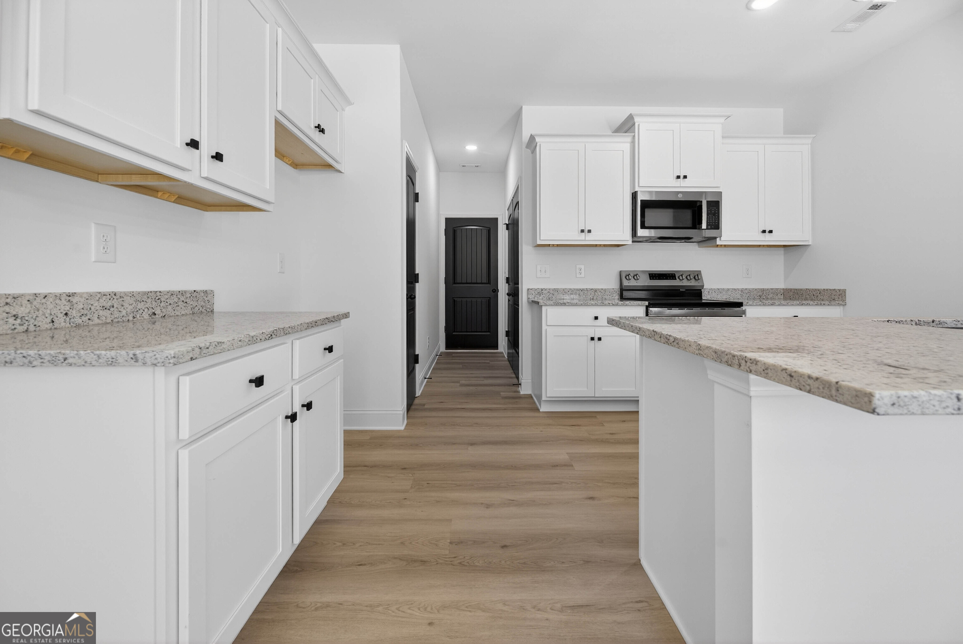 707 Oakmont Trail Villa Rica, GA 30180 - Photo 9 of 33 a kitchen with stainless steel appliances granite countertop a sink and a stove