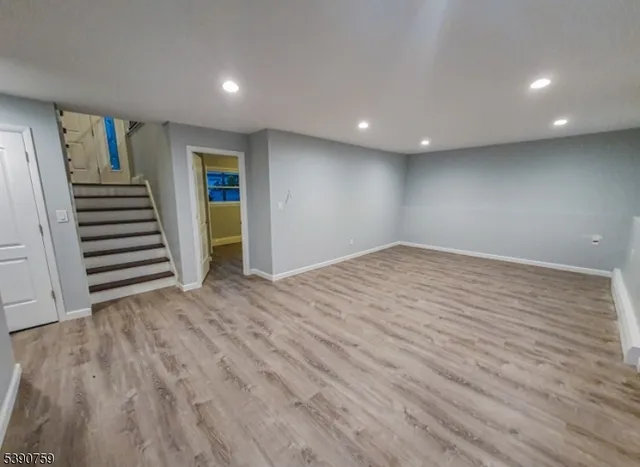 a view of a room with wooden floor and stairs