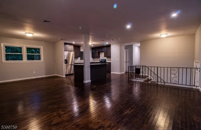 an open kitchen view with wooden floor and a kitchen
