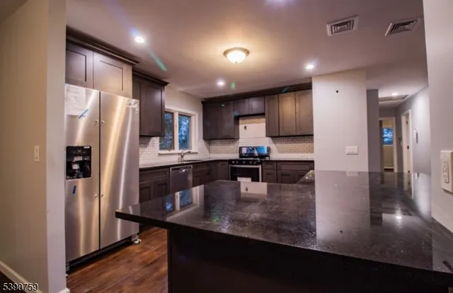 a kitchen with counter top space cabinets and stainless steel appliances