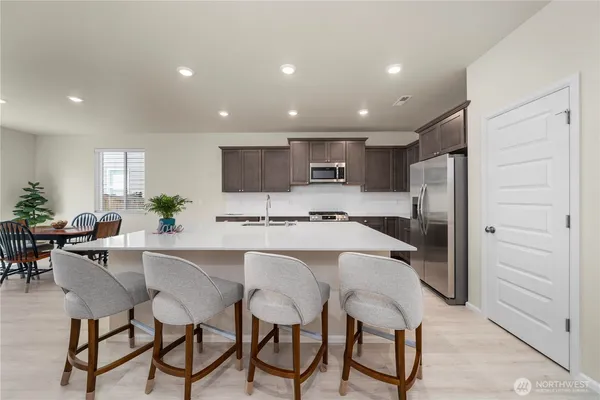 a kitchen with a table and chairs in it