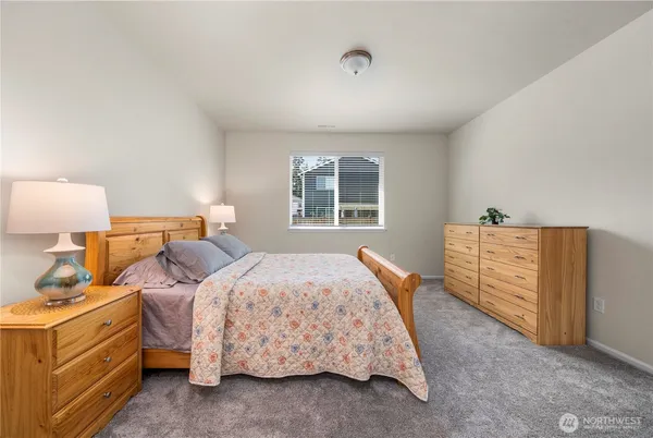 a bedroom with a bed and a dresser