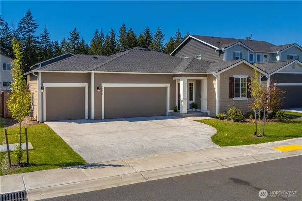 a front view of a house with a yard and garage