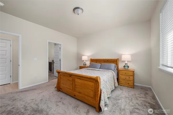 a bedroom with a bed and a lamp