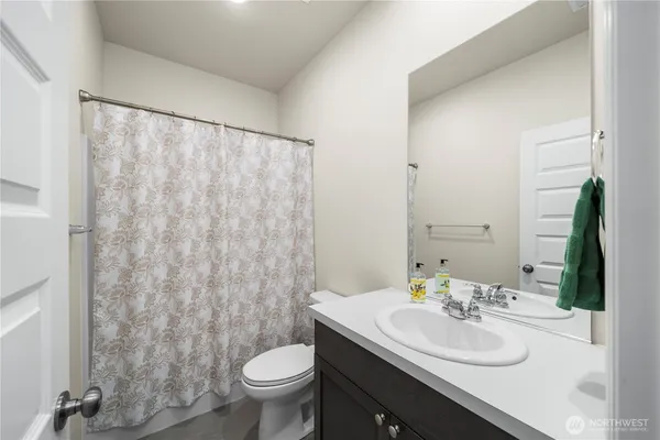 a bathroom with a sink toilet and mirror