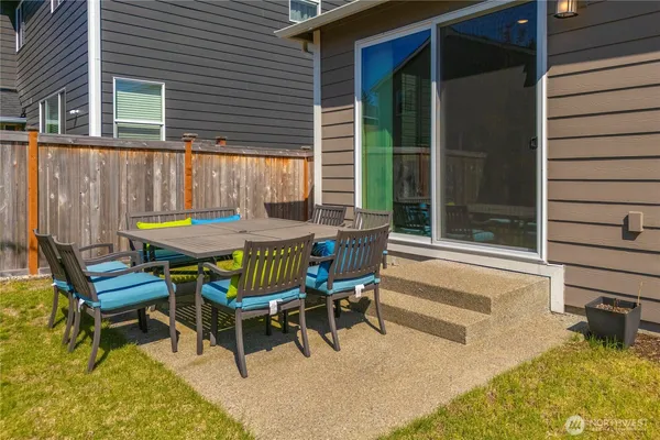 a view of a backyard with a patio and outdoor seating