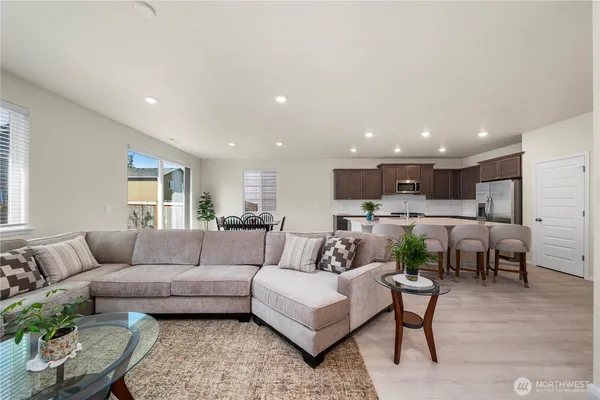 a living room with furniture kitchen view and a table