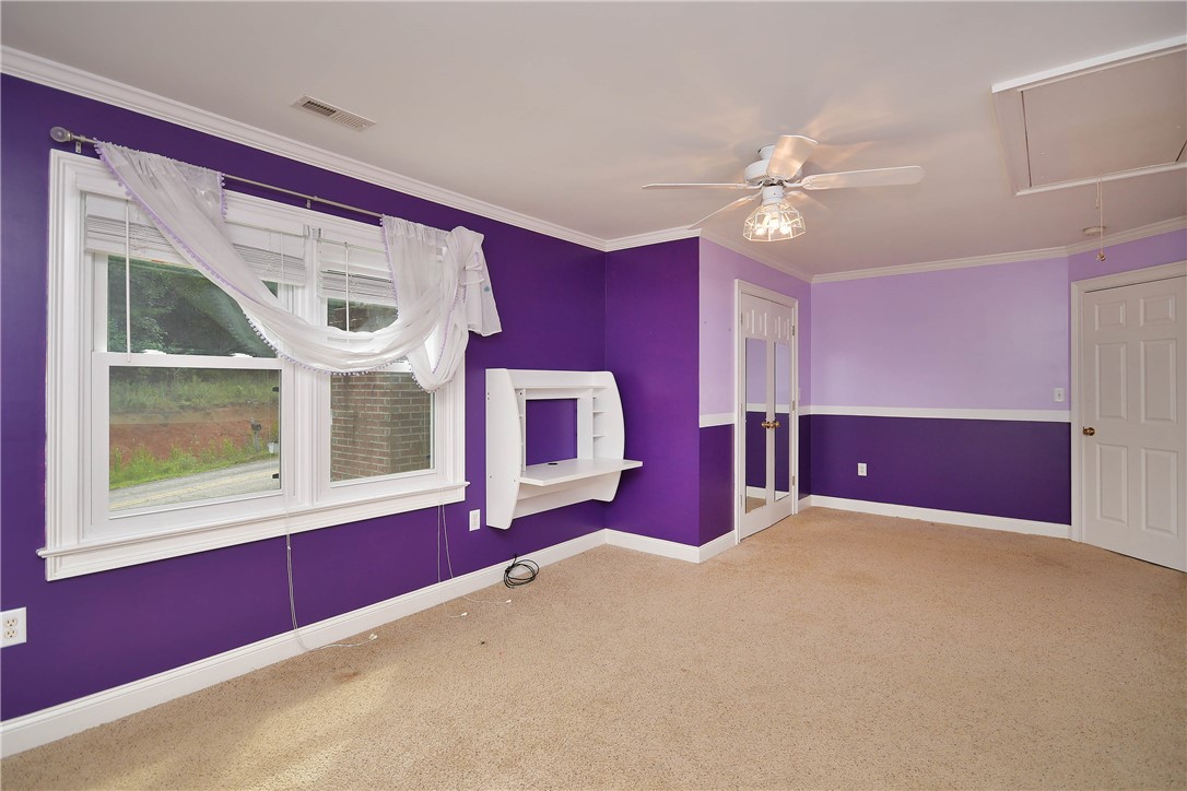 197 Deer Creek Road Easley, SC 29640 - Photo 26 of 50 A cheerful room featuring a functional built-in desk, plush carpeting, and bright, sun-filled windows.