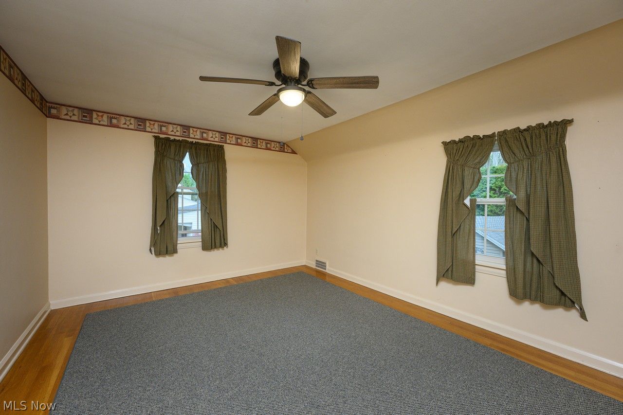 1422 Monument Road Northwest Canton, OH 44703 - Photo 14 of 31 Bedroom with multiple windows, ceiling fan and hardwood floors