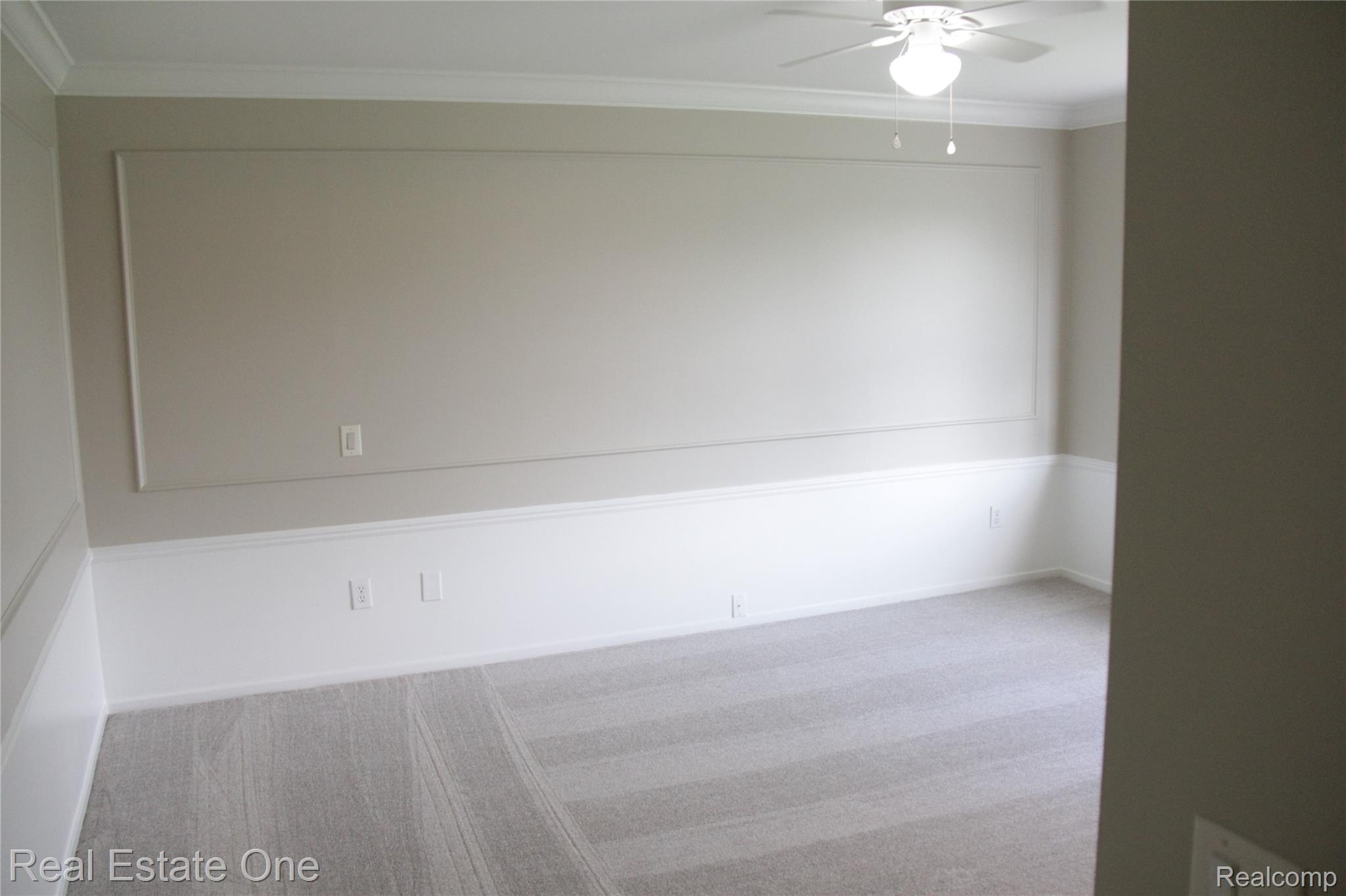 44777 Saltz Road Canton, MI 48187 - Photo 37 of 65 Spacious Primary bedroom featuring light gray carpet flooring, white wainscoting, and crown molding