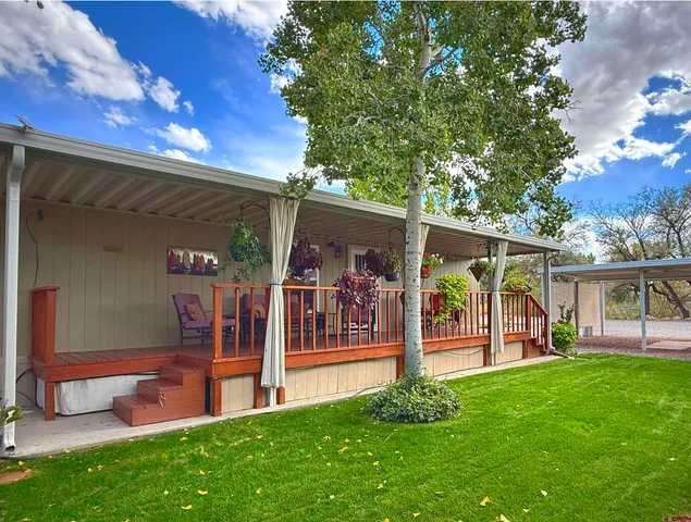 a view of a house with a backyard porch and sitting area