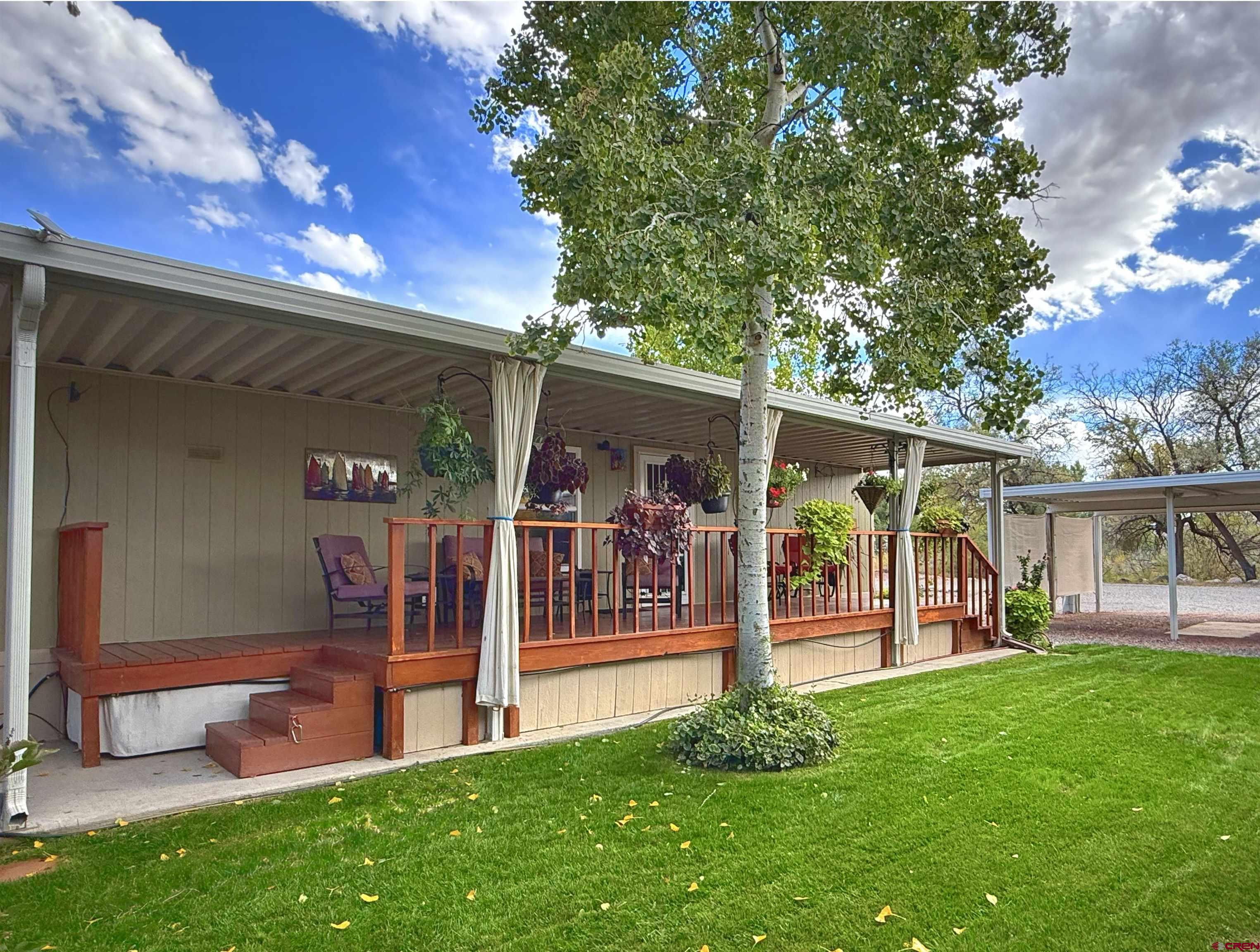 a view of a house with a backyard porch and sitting area