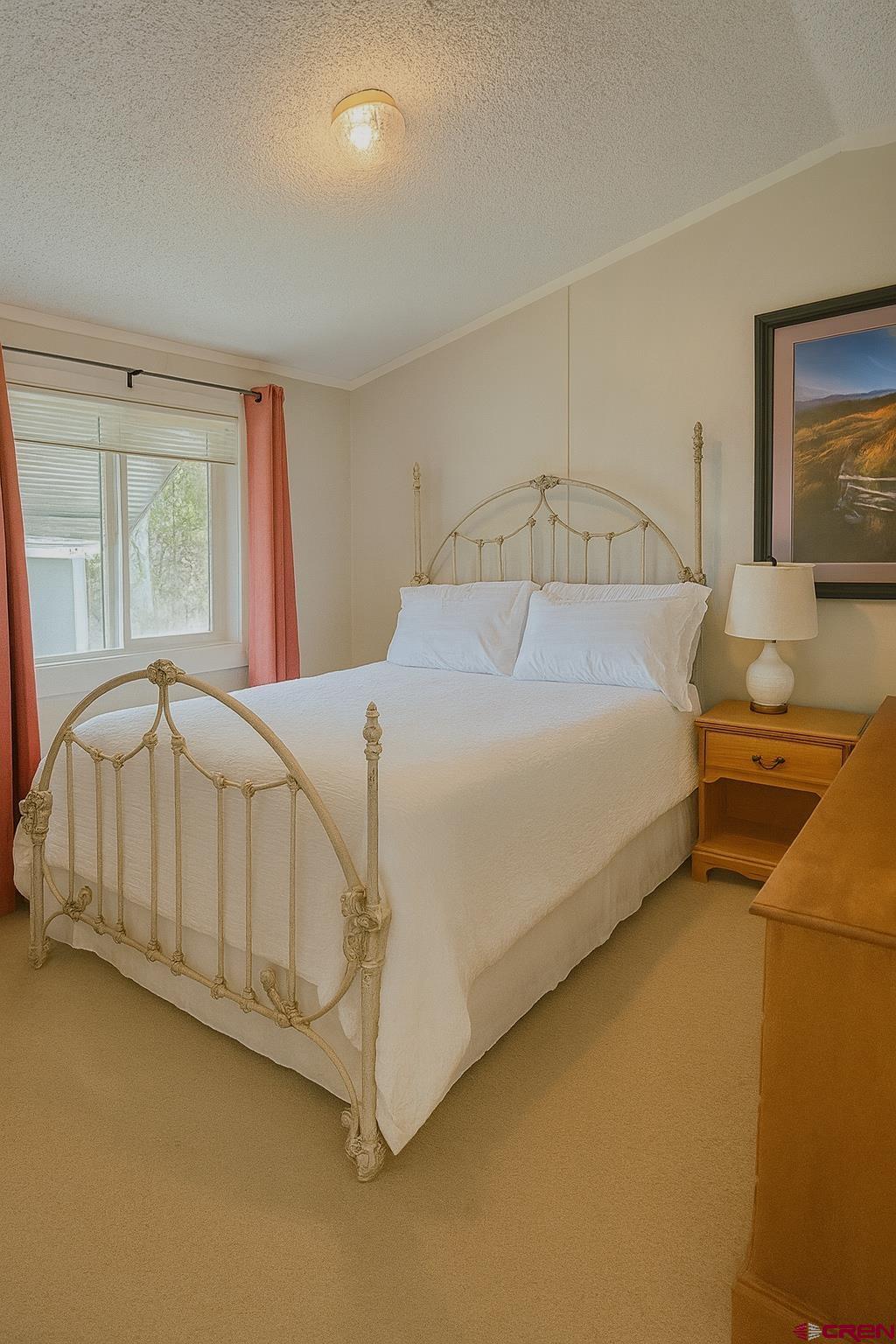 676 Highway 50, Unit SPACE #43 Delta, CO 81416 - Photo 20 of 33 a bedroom with a bed a table and painting