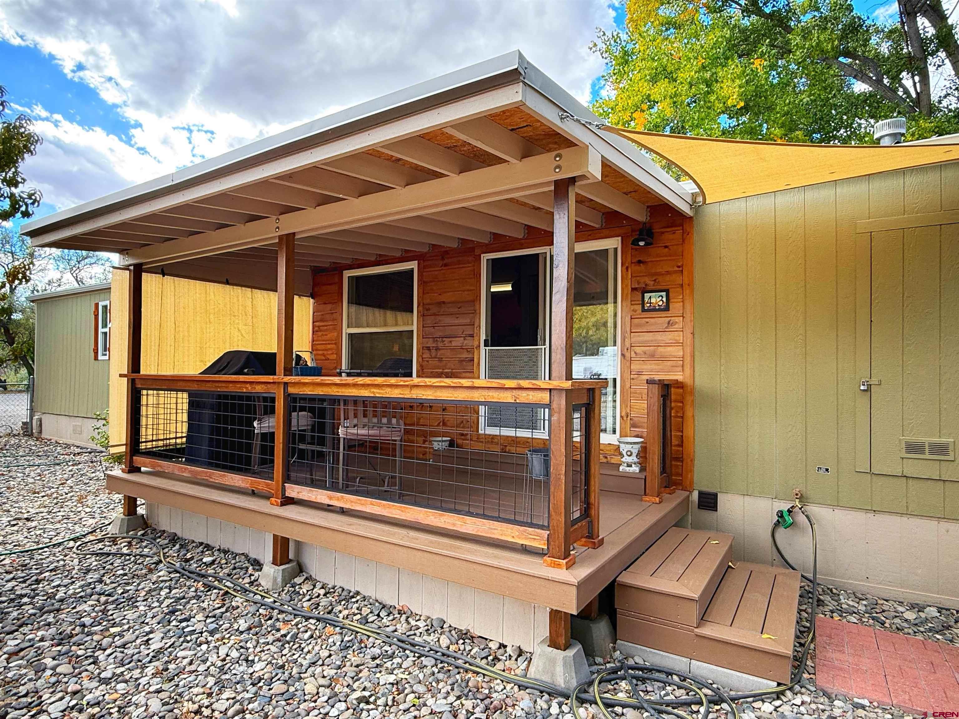 676 Highway 50, Unit SPACE #43 Delta, CO 81416 - Photo 24 of 33 a view of a house with a large window and wooden fence