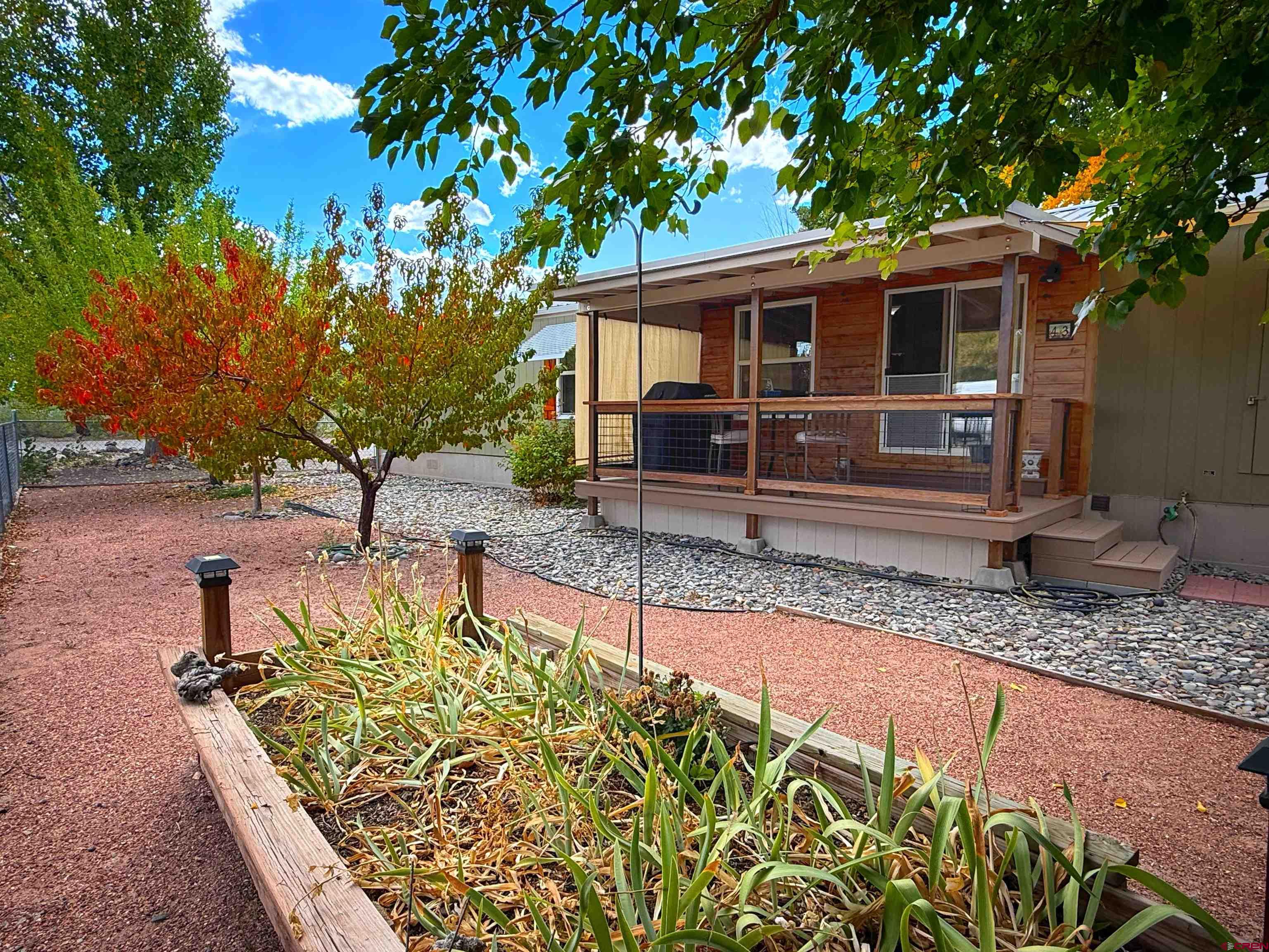 676 Highway 50, Unit SPACE #43 Delta, CO 81416 - Photo 25 of 33 a front view of a house with garden