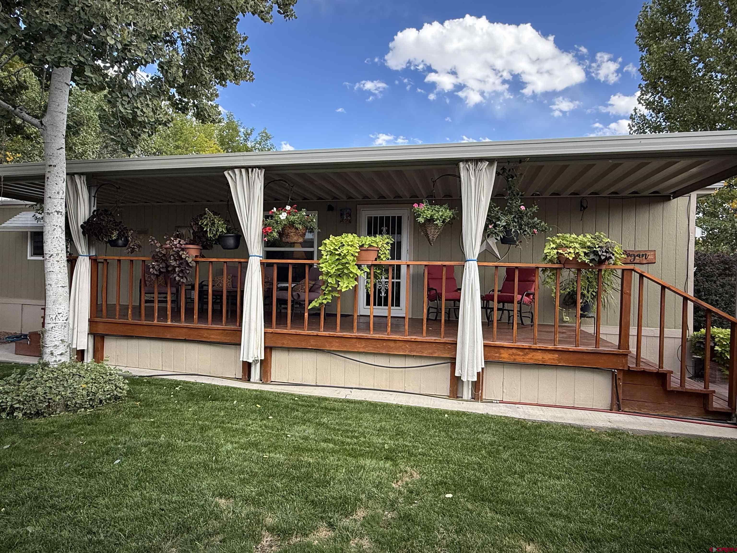 676 Highway 50, Unit SPACE #43 Delta, CO 81416 - Photo 5 of 33 a view of a house with a porch and a garden