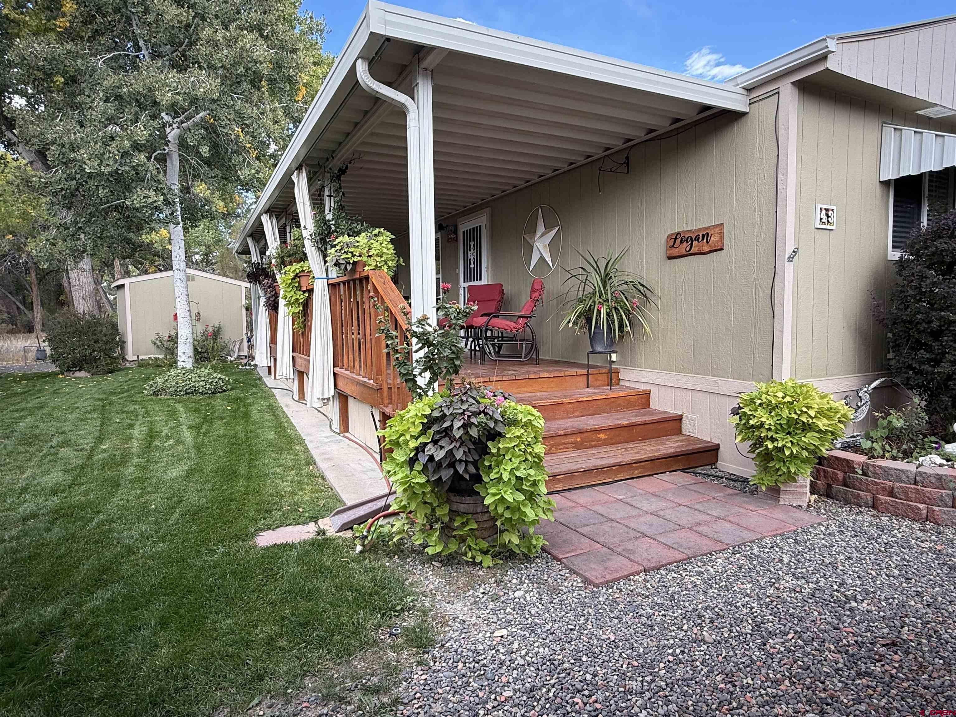 676 Highway 50, Unit SPACE #43 Delta, CO 81416 - Photo 6 of 33 a front view of house with yard
