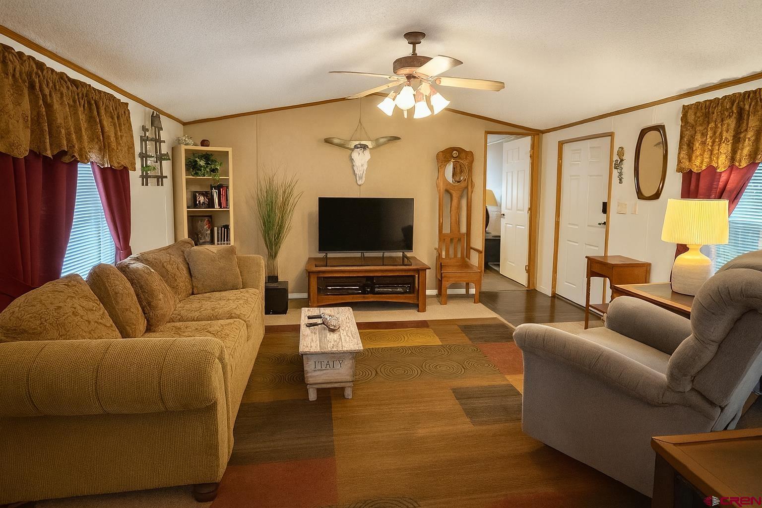 676 Highway 50, Unit SPACE #43 Delta, CO 81416 - Photo 10 of 33 a living room with furniture and a flat screen tv