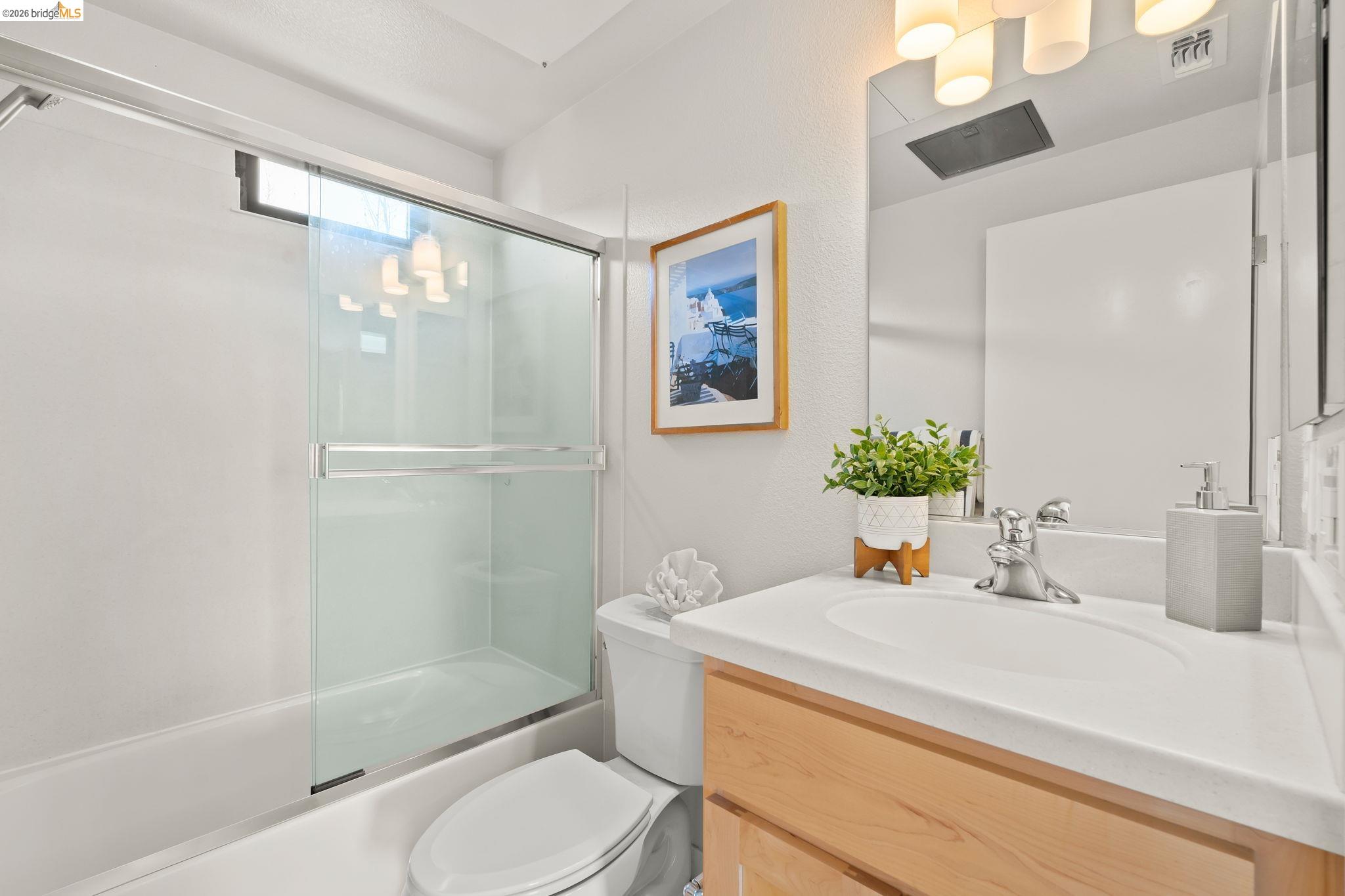1780 12th Street Oakland, CA 94607 - Photo 20 of 31 a bathroom with a sink a toilet and shower