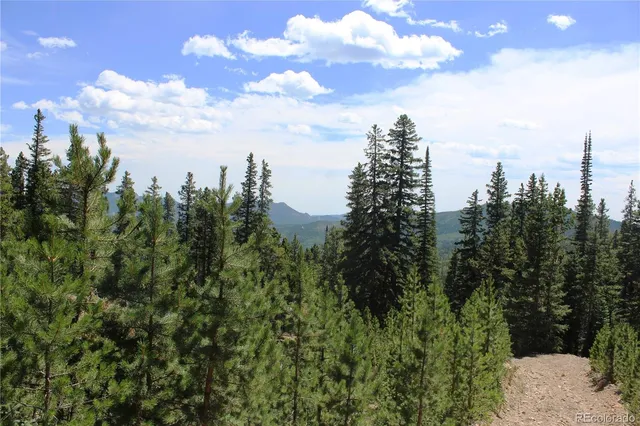 a view of a city with lush green trees