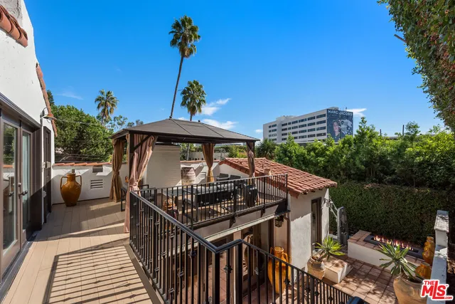 a view of balcony with furniture and potted plants