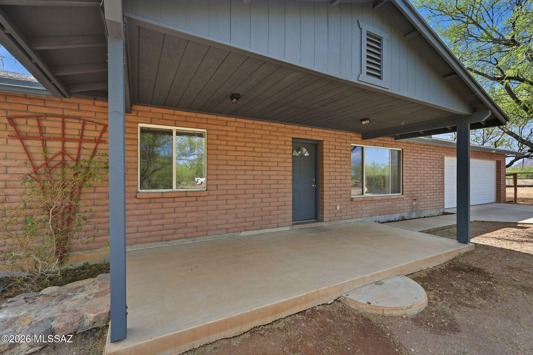 1462 Circulo Sombrero Rio Rico, AZ 85648 - Photo 2 of 50 Spacious front porch gives space for patio set for lounging.