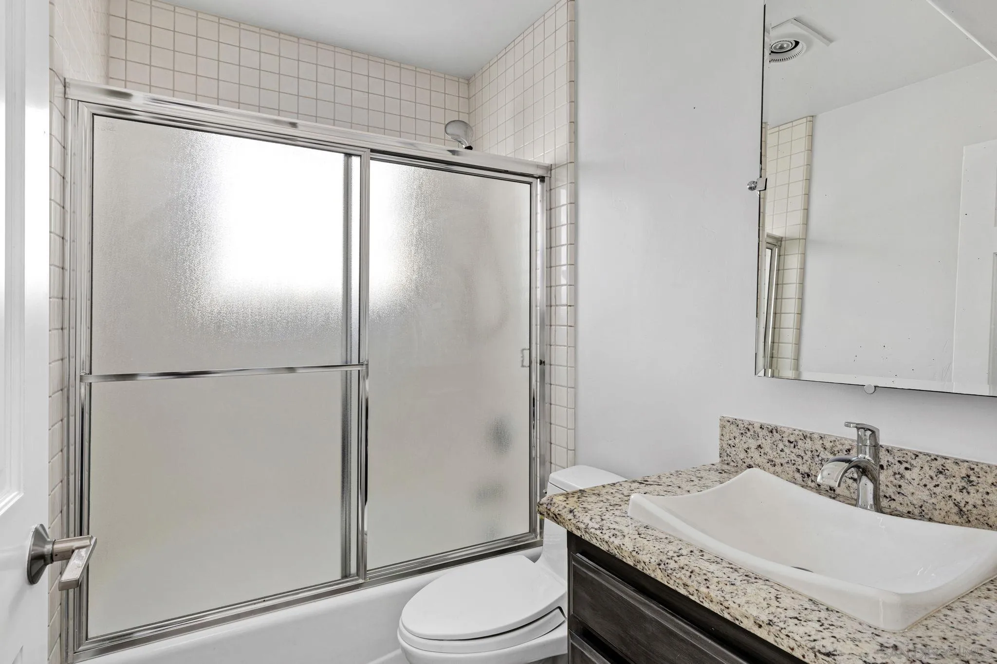 200 Pine Street, Unit 1 Oceanside, CA 92054 - Photo 19 of 28 a bathroom with a granite countertop sink toilet and shower