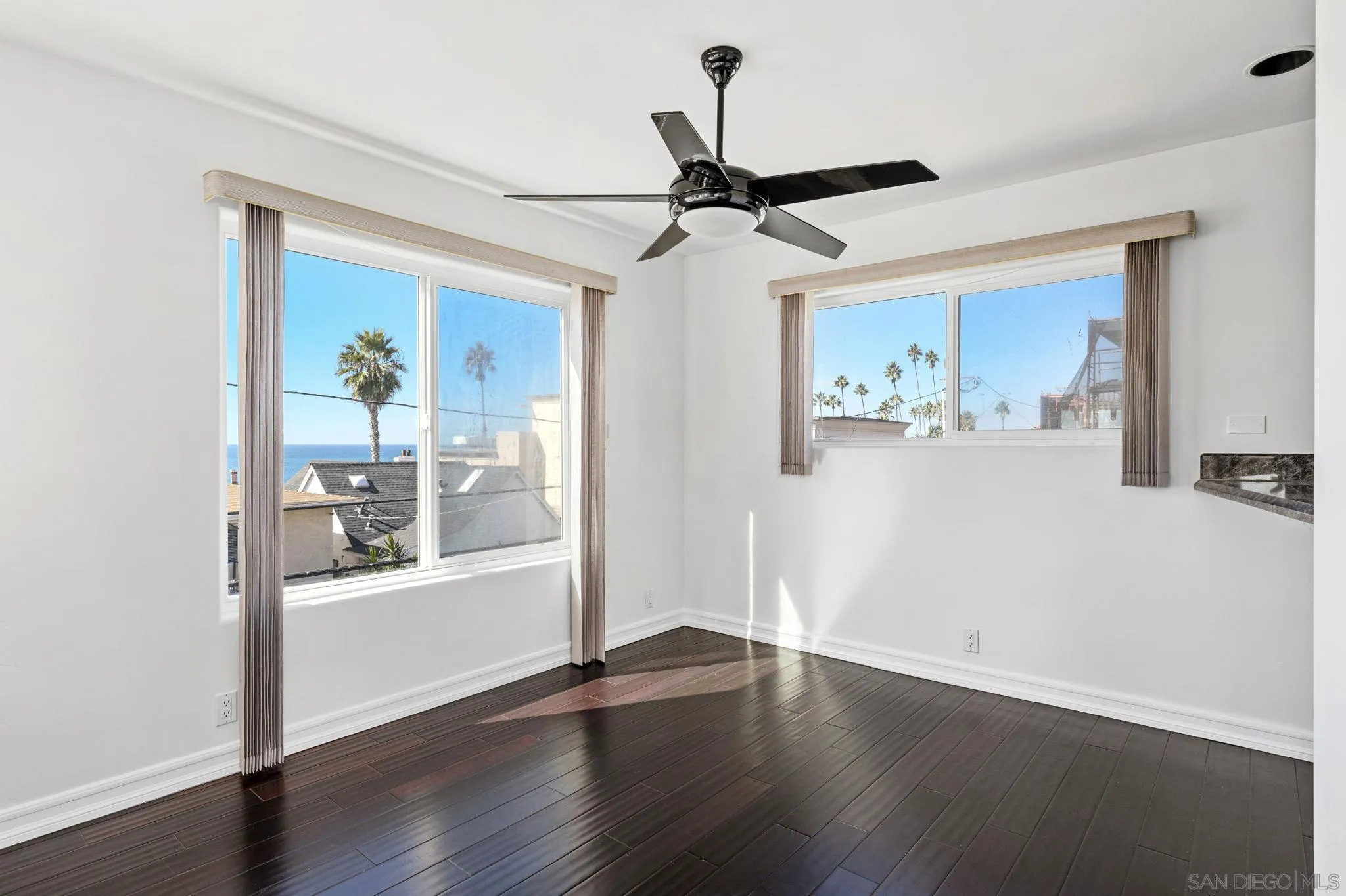 200 Pine Street, Unit 1 Oceanside, CA 92054 - Photo 8 of 28 a view of a livingroom with wooden floor and a ceiling fan