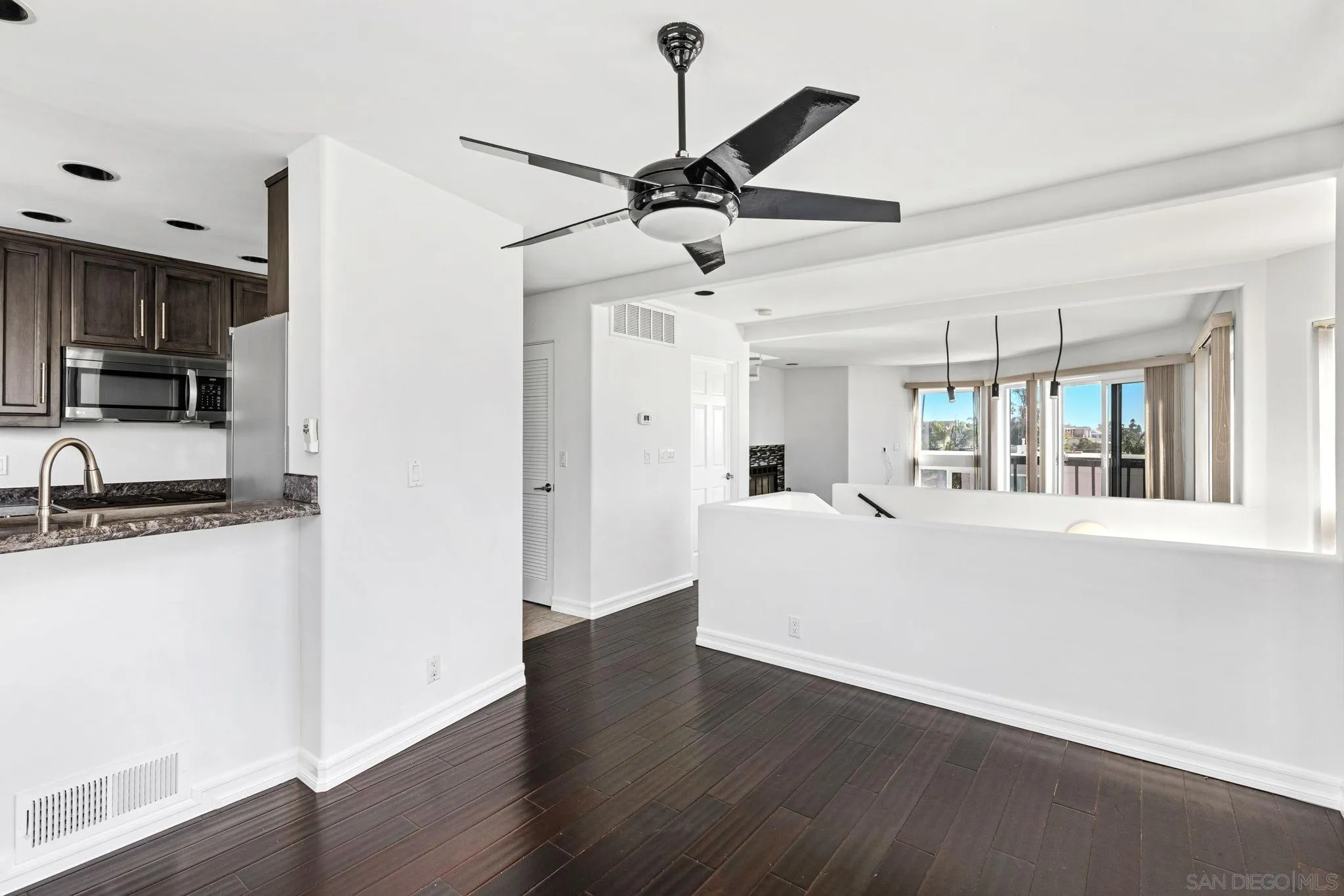 200 Pine Street, Unit 1 Oceanside, CA 92054 - Photo 10 of 28 a living room with stainless steel appliances kitchen island granite countertop a refrigerator a stove a sink and a window