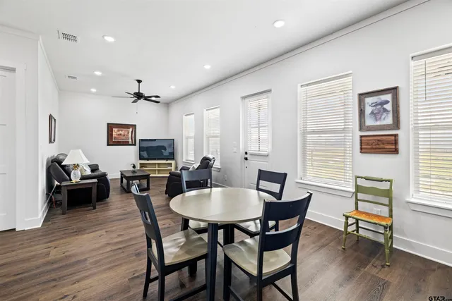 a view of a dining room with furniture and wooden floor