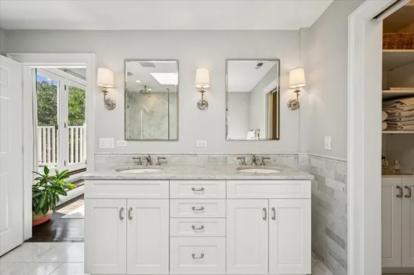 a white bath tub sitting next to a shower